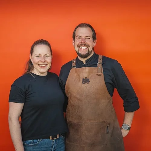 Two people against an orange background